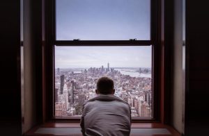 man-in-gray-shirt-looking-at-city-buildings-3625023-1