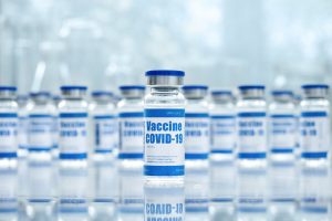 Covid 19 corona virus vaccine vial bottles for intramuscular injections on medical pharmaceutical industry background. Coronavirus cure manufacture, flu treatment drug pharmacy production concept.