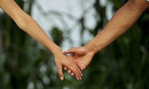 Couple holding hands, close-up